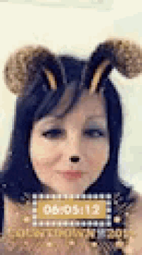 a woman is wearing a bee mask and a countdown clock on her face .