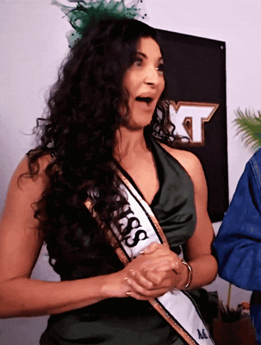 a woman wearing a sash that says miss