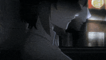 a woman 's face is shown in a dark room with a clock in the background