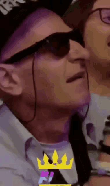 a man wearing sunglasses and a hat with the word king on it