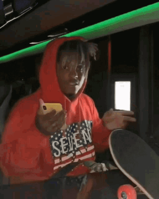 a person wearing a red hoodie that says seahawks on it