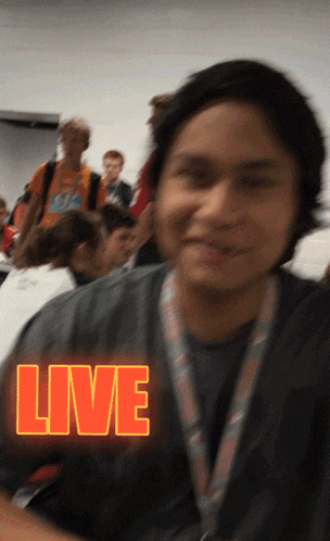 a person with a lanyard around their neck and the word live on it