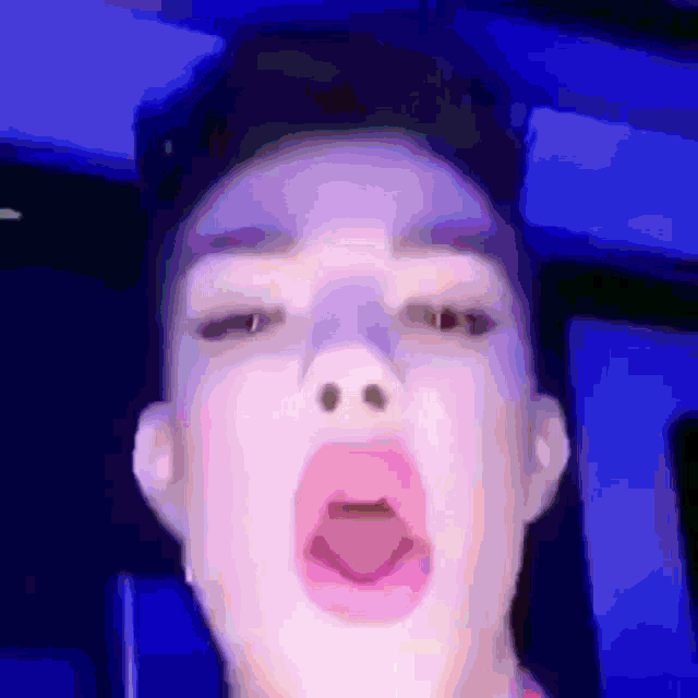 a close up of a person 's face with their tongue sticking out