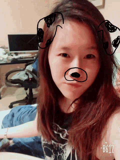 a girl with a drawing of a dog on her face and the number b612
