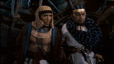 two men are standing next to each other with one wearing a striped head scarf