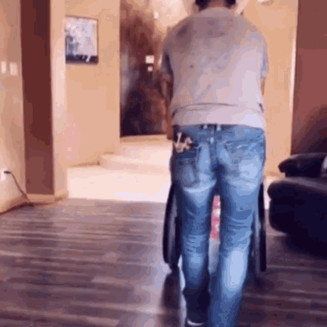 a person in a wheelchair is walking through a living room