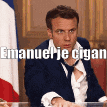a man in a suit and tie is sitting in front of a flag with the words emanuel je cigan written on it