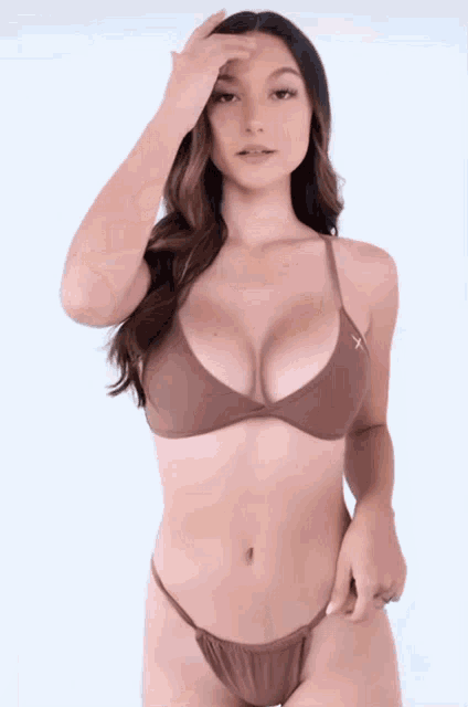 a woman in a bikini with a cross on the top