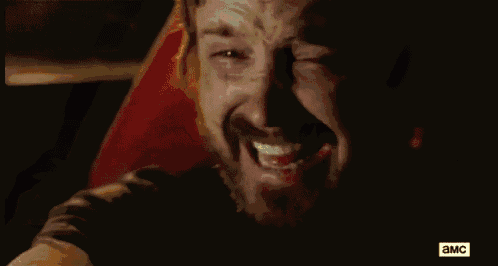 a close up of a man 's face with blood on it and the word a & mc on the bottom