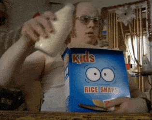 a man is holding a box of kids rice snaps