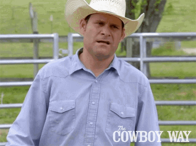 a man wearing a cowboy hat and a blue shirt has the cowboy way written on the bottom