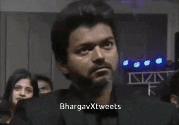 a man in a plaid shirt says bhargavxtweets on the bottom