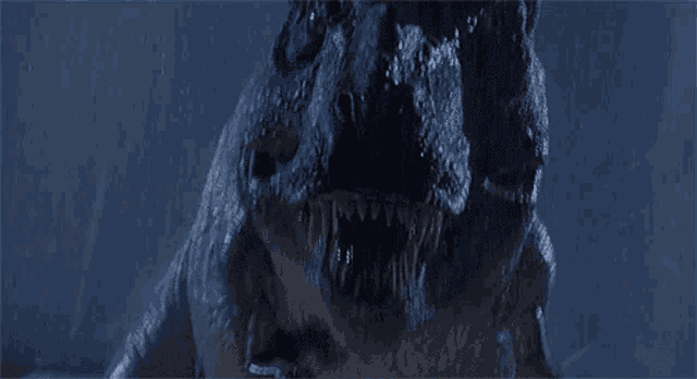 a close up of a t-rex with its mouth open
