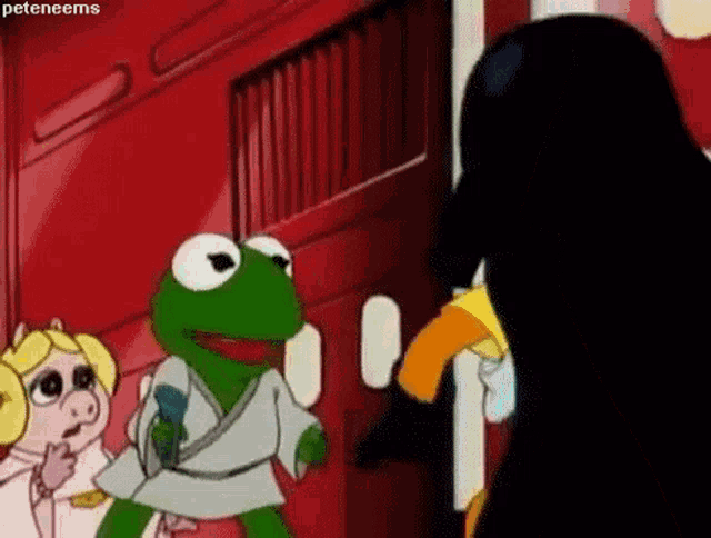 kermit the frog is standing next to miss piggy and a black penguin .