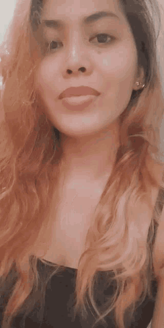 a close up of a woman 's face with a smile on her face