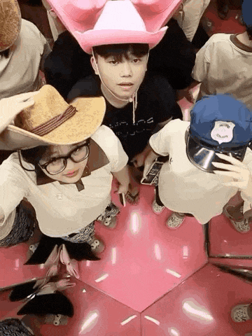 a group of people wearing cowboy hats and police hats are taking a selfie