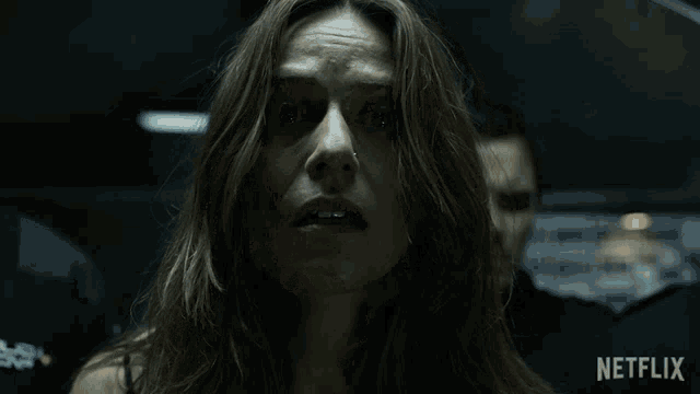 a close up of a woman 's face with the netflix logo in the corner