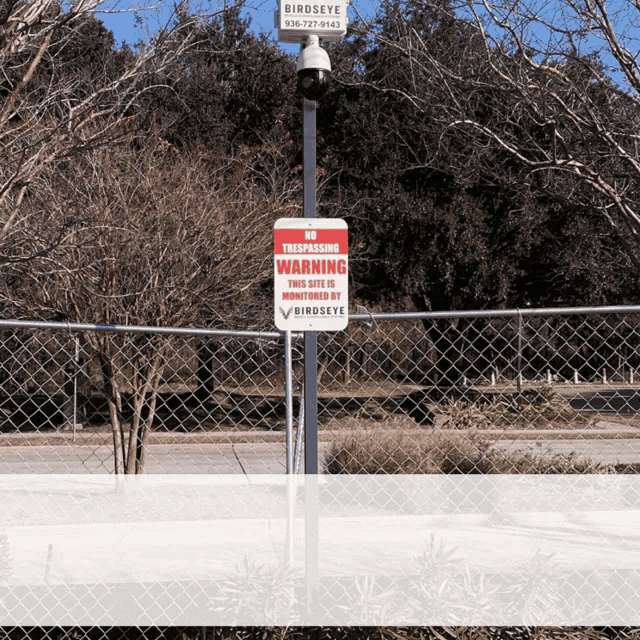 a no trespassing warning sign that is outside