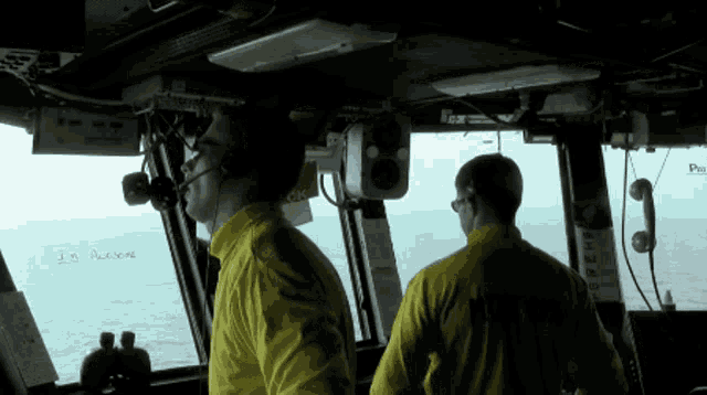 a man wearing a yellow shirt that says navy on it