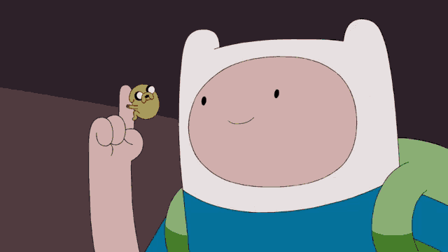 a cartoon character holds a small jack o ' lantern on his finger