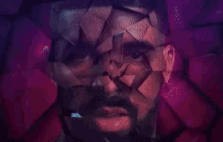 a close up of a man 's face with a beard and glasses in a purple background