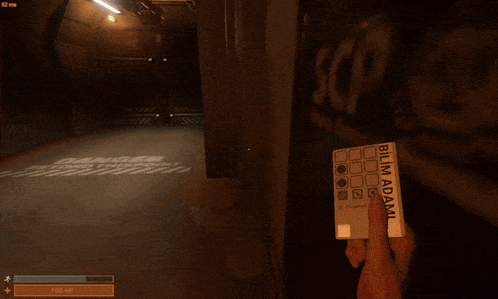 a person is holding a card that says bilim adami on it