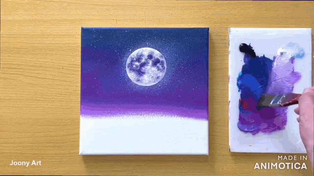 a painting of a full moon is being painted on a canvas by joony art