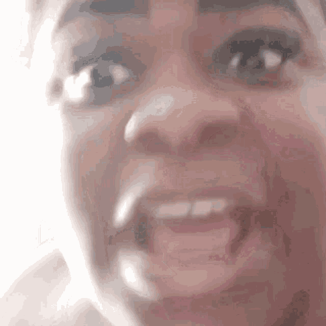 a close up of a woman 's face with her mouth open and her tongue sticking out .