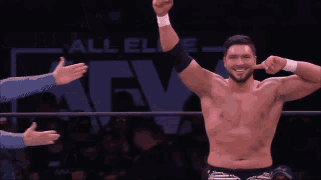 a shirtless wrestler is making a funny face with his fingers
