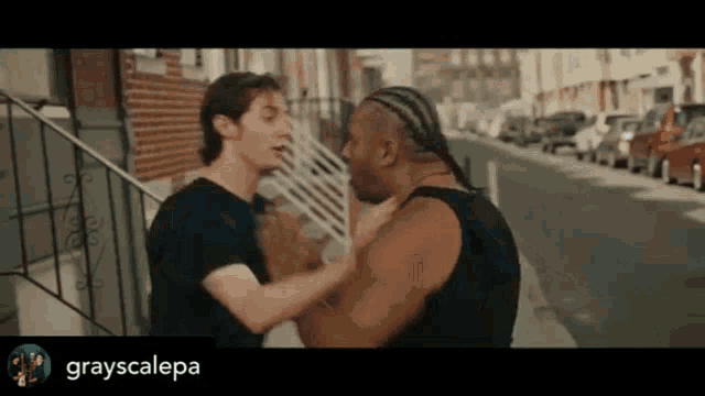 two men are standing on a sidewalk with grayscalepa written on the bottom right corner