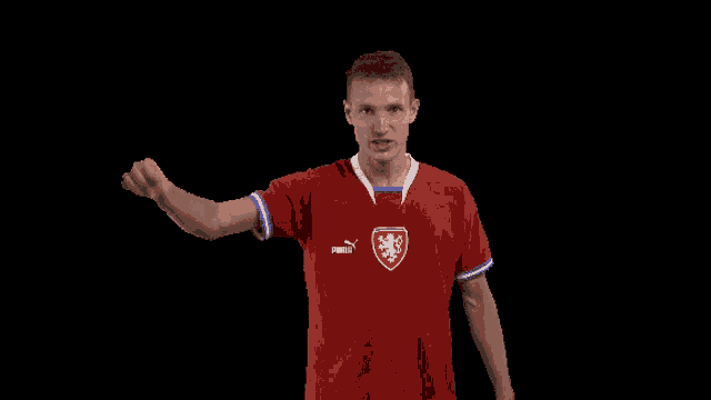 a man in a red puma shirt with a lion on the front