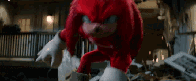 knuckles the echidna from the video game sonic the hedgehog is standing in front of a destroyed house .