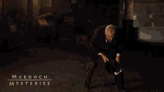 a poster for murdoch mysteries shows a man in a suit