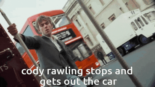 cody rawling stops and gets out the car in front of a red bus