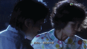 a man and a woman are looking at each other in a scene from a movie