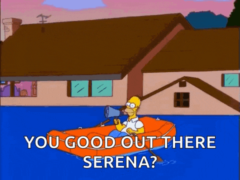 homer simpson is holding a megaphone while sitting in a raft in the water .