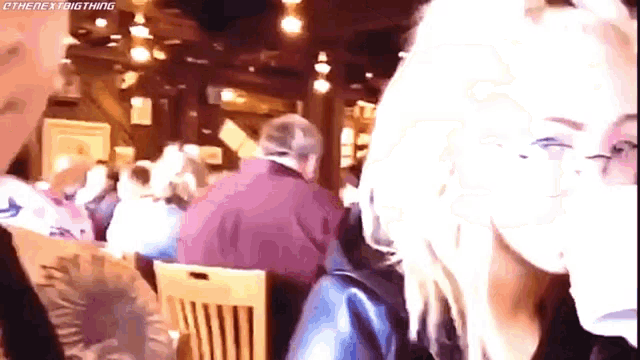 a group of people are sitting at tables in a restaurant with a watermark that says etherexbigthing