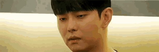 a close up of a young man 's face with a sad expression .