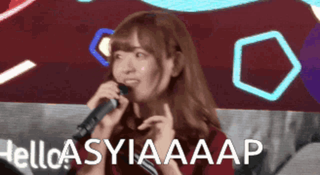 a girl singing into a microphone with the words hello asyiaaap written below her