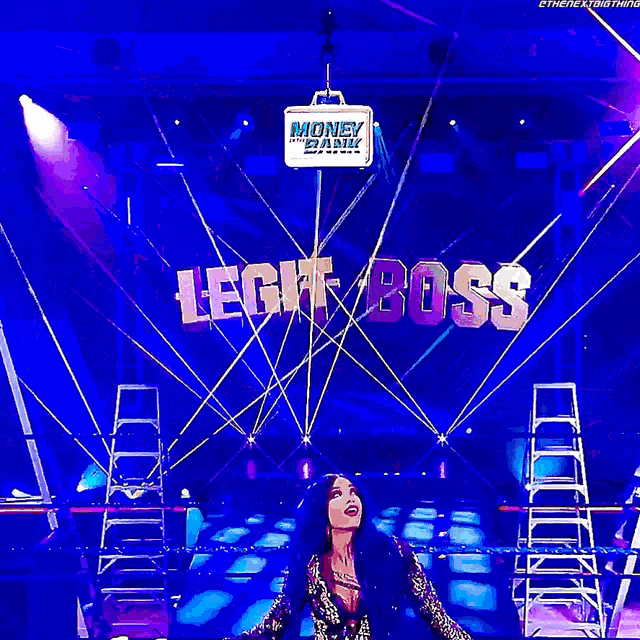 a woman is standing in front of a banner that says legit boss
