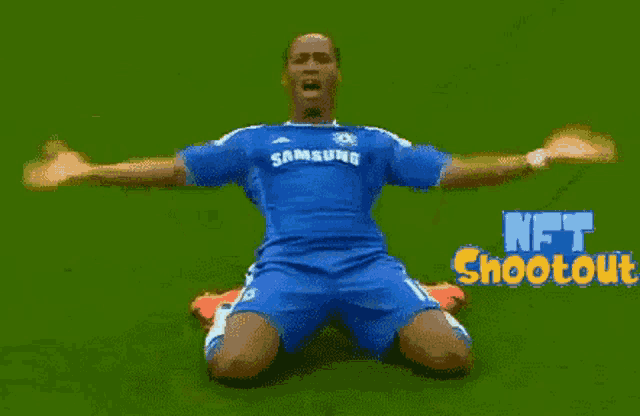 a soccer player in a blue samsung jersey is kneeling down