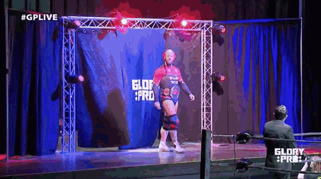 a man in a wrestling ring with the word glory pro on the back
