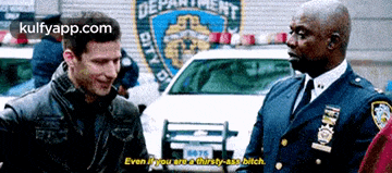 two police officers are talking to each other in front of a new york city police department car .