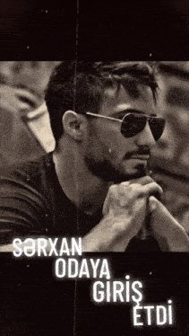 a black and white photo of a man wearing sunglasses and the name sarxan odaya