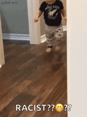 a baby is running in a hallway and says racist