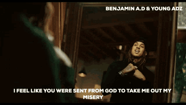 a benjamin a.d. & young adz video shows a man with dreadlocks standing in front of a window