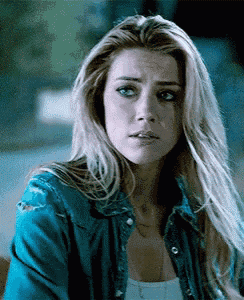 a woman with long blonde hair wearing a blue denim jacket