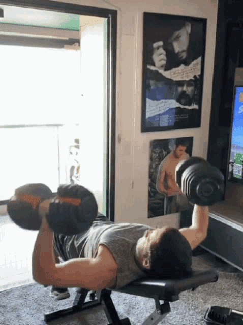 a man is lifting a dumbbell on a bench