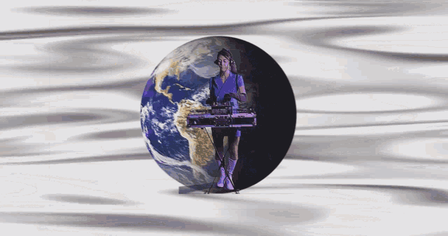 a woman playing a keyboard in front of the earth
