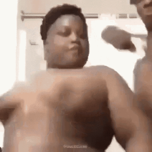 a man and a woman are standing next to each other in a bathroom and dancing .